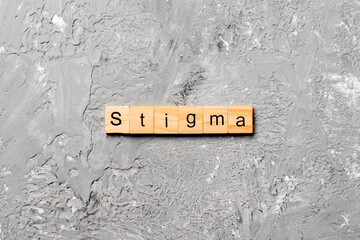 stigma word written on wood block. stigma text on table, concept