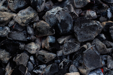 Black hot coal, close-up. Black charcoal background