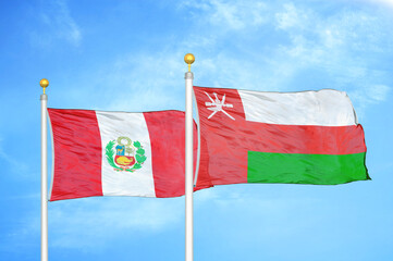 Peru and Oman two flags on flagpoles and blue sky