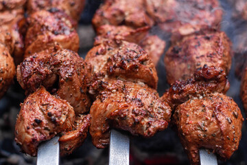 Delicious shish kebab is prepared on the grill