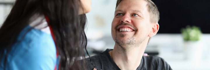 Obraz premium Smiling man looks at doctor woman with confidence. Restoration ability people with disabilities to household, social activities. Rehabilitation in clinic. Restore and adapt to life after an accident