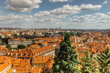 Fototapeta na wymiar Amazing European cityscape.Aerial view of old town with hictorical buildings,red roofs,churches,skyscrapers in Prague,Czechia.Prague panorama.Beautiful sunny landscape of the capital of Czechia.