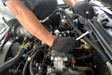 The mechanic is fixing the engine