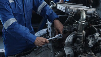 Mechanic auto mechanic in uniform repairing.car in auto machine tools ready to be used with car service.selective focus.