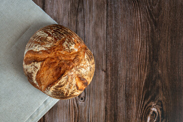 Fresh bread on wooden table. Top view with space for text