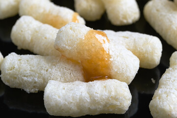 Corn air sticks in powdered sugar