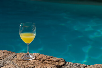 a peaceful pool moment with a glass of orange juice