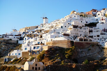 Naklejka premium Sunset lights up the beautiful city, Thira, Greece, Europe