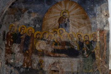 Fototapeta na wymiar Timeworn Byzantine fresco 'The Dormition of the Virgin Mary' in old chapel, Paleochora - Aegina, Greece