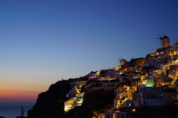 Sunset view and beautiful buildings lighted by sunset in santorini island, Greece, Europe