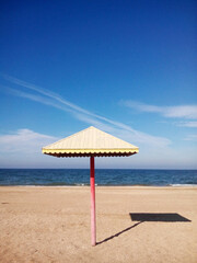Beach umbrella on the sandy seashore