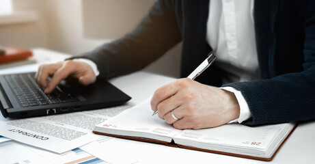 Fototapeta premium Cropped view of businessman works with financial papers at the table. Finance concept