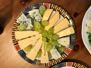 Tasty Cheese Plate with Roquefort Blue Holland Cheese and Green Grape.