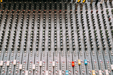 Fototapeta premium Professional sound and audio mixer control panel with buttons and sliders