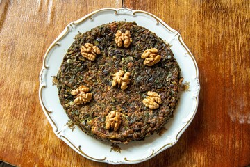 Azerbaijani style Persian herb “Kuku” dish topped with walnuts