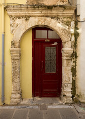 Fototapeta na wymiar Medieval gate and modern time door in modern Rethymno, Crete island, Greece. 
