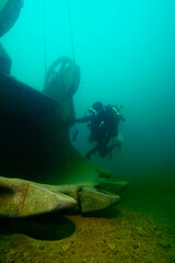Scuba diver explores excavator wreck in a fresh water lake © frantisek hojdysz