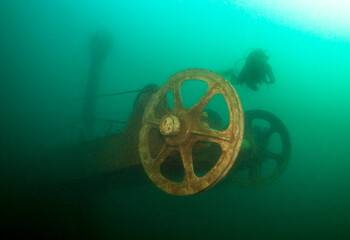 Scuba diver explores excavator wreck in a fresh water lake © frantisek hojdysz