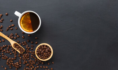 hot coffee, bean and hand grinder on black table background. space for text. top view