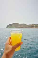 glass of orange juice in hand