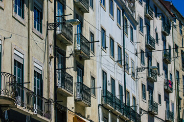View of classic facade of ancient historical buildings in the downtown area of Lisbon, the hilly coastal capital city of Portugal and one of the oldest cities in Europe
