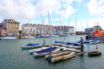Sailing boats in the old town of Weymouth Harbour in Dorset, England, UK.