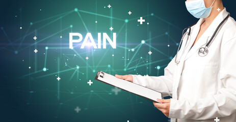Doctor fills out medical record with PAIN inscription, medical concept