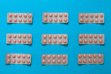 Drug pillls in blister pack on table with colorful background