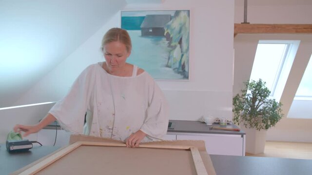 Female painter working on painting in her studio