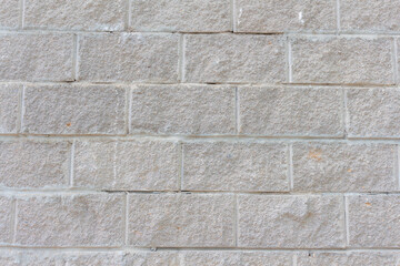 View of old shabby wall made from gray bricks. Abstract textured background. Copy space for your text and decorations.