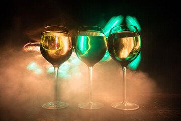 Goblet of white wine on wooden table on wooden wall background
