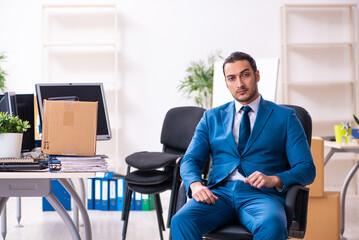 Young male employee in moving concept