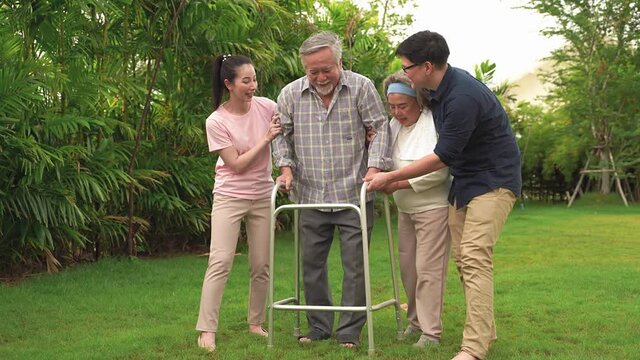 The old man was walking with a walker in the backyard, with a family with a wife, daughter and son to support, until he could walk on his own without a walker to help with. Asian family theme that Ver