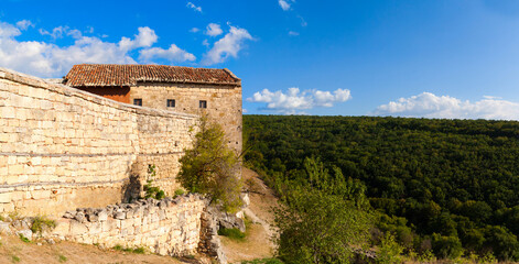 Ancient road with deep ruts and gate in Medieval cave city-fortress Chufut-Kale in the mountains, Bakhchisaray, Crimea.