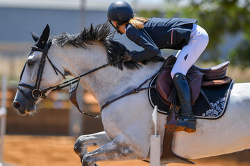 Rider jumps over obstacles during horse show jumping