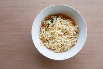 dry tomyum noodle on wooden table