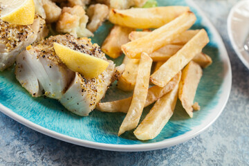 Steamed cod fish with french fries and boiled cauliflower
