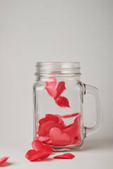 red hearts on a white background in a glass jar