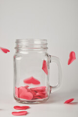 red hearts on a white background in a glass jar