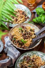 Plate of pasta with forest chanterelles and basil