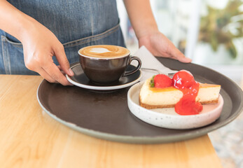 cake with strawberry jam and hot cappuccino coffee with hand girl serving 