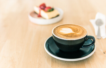 black cup of cappuccino coffee and cake