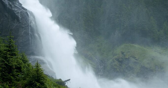 Side view of powerful well known Krimml Waterfalls the highest in Austria. European Alps landscape with forest