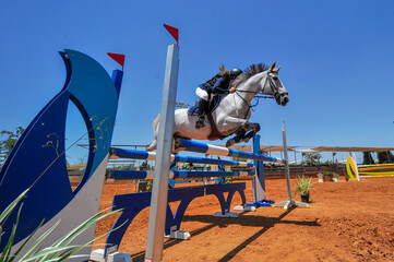 Rider jumps over obstacles during horse show jumping