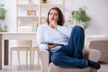 Young male student preparing for exams at home