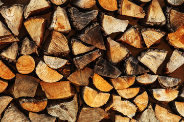 A stack of firewood for heating a country house. Wood texture lumber close up