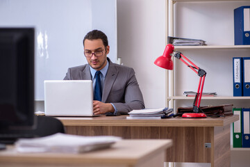 Fototapeta premium Young male businessman employee working in the office