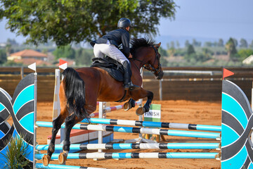 Rider jumps over obstacles during horse show jumping