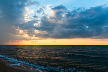 Naklejka na ściany i meble sea tide and beautiful sunset on the beach
