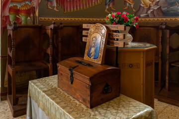 The table with donation box in the main hall of the Church of the Apostles located on the shores of the Sea of Galilee, not far from Tiberias city in northern Israel